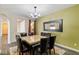 Well-lit dining room features a chandelier, a mirror and a stylish dining table at 9240 Northfield Park Ct, Las Vegas, NV 89148