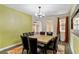 Elegant dining area with a wooden table, seating for eight, and access to other living spaces at 9240 Northfield Park Ct, Las Vegas, NV 89148