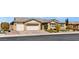Inviting single-story home with a neutral color palette, three-car garage, and well-manicured front yard at 9240 Northfield Park Ct, Las Vegas, NV 89148