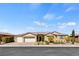 Inviting single-story home with a neutral color palette, three-car garage, and well-manicured front yard at 9240 Northfield Park Ct, Las Vegas, NV 89148