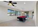 Bright game room featuring a pool table, tile flooring, and natural light from large windows at 9240 Northfield Park Ct, Las Vegas, NV 89148