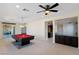 Open game room with pool table, ceiling fan, and access to outdoor living space at 9240 Northfield Park Ct, Las Vegas, NV 89148