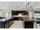 Well-designed kitchen showcasing dark cabinetry, granite countertops, dual islands and modern lighting at 9240 Northfield Park Ct, Las Vegas, NV 89148