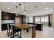 Spacious kitchen with dark cabinetry, granite countertops, and pendant lighting above the island at 9240 Northfield Park Ct, Las Vegas, NV 89148