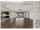 Expansive living room with dark wood floors, recessed lights, and backyard view at 9240 Northfield Park Ct, Las Vegas, NV 89148