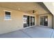Covered patio with ceiling fan and multiple sliding glass doors at 9240 Northfield Park Ct, Las Vegas, NV 89148