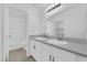 Modern bathroom with a double sink vanity, sleek countertops, and ample lighting at 9315 Indian Corn Ct # 101, Las Vegas, NV 89178