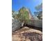 Fenced backyard area with mature trees and a low-maintenance xeriscaped space perfect for outdoor relaxation at 9617 Pine River Ln, Las Vegas, NV 89123