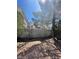 Fenced backyard area with mature trees and a low-maintenance xeriscaped space perfect for outdoor relaxation at 9617 Pine River Ln, Las Vegas, NV 89123