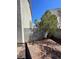 Fenced backyard area with mature trees and a low-maintenance xeriscaped space perfect for outdoor relaxation at 9617 Pine River Ln, Las Vegas, NV 89123