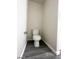Small bathroom featuring a toilet and grey wood-look floors, perfect for a guest at 9617 Pine River Ln, Las Vegas, NV 89123