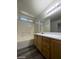 Bathroom with a tub and shower combination, a vanity, and ample natural light at 9617 Pine River Ln, Las Vegas, NV 89123