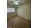 Bedroom featuring a ceiling fan, window, carpeted floor, and neutral color palette at 9617 Pine River Ln, Las Vegas, NV 89123