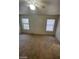 Bedroom featuring a ceiling fan and two windows, offering natural light at 9617 Pine River Ln, Las Vegas, NV 89123