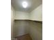 Walk-in closet with shelving, carpeted floor, and neutral color palette at 9617 Pine River Ln, Las Vegas, NV 89123