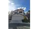 Two-story home featuring an attached two-car garage and neutral stucco exterior at 9617 Pine River Ln, Las Vegas, NV 89123