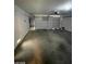 A two-car garage with an automatic door and concrete floor providing secure parking and storage space at 9617 Pine River Ln, Las Vegas, NV 89123