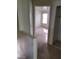 Hallway leading to a bedroom with window and ceiling fan at 9617 Pine River Ln, Las Vegas, NV 89123