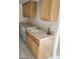 Kitchen with stainless sink, light wood cabinets, and bright countertop at 9617 Pine River Ln, Las Vegas, NV 89123