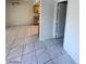 Bright living room features modern tile floors and easy access to kitchen at 9617 Pine River Ln, Las Vegas, NV 89123