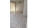 Living room with sliding glass doors to patio and marble-look floor tiles throughout at 9617 Pine River Ln, Las Vegas, NV 89123