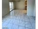 Bright living room features marble-look floor tiles, and sliding glass doors to the backyard at 9617 Pine River Ln, Las Vegas, NV 89123