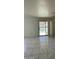 Bright living room features modern tile floors and access to outdoor pool area at 9617 Pine River Ln, Las Vegas, NV 89123