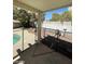 Covered patio and safety fencing surrounding a freeform swimming pool at 9617 Pine River Ln, Las Vegas, NV 89123