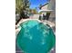 Backyard freeform swimming pool featuring a built-in set of steps at 9617 Pine River Ln, Las Vegas, NV 89123