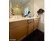 This bathroom features cabinets under the sink for easy and convenient storage at 9801 Bradford Summit St, Las Vegas, NV 89183