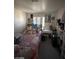 Cozy bedroom features a bed with a patterned comforter, a desk with a stool, and closet at 9801 Bradford Summit St, Las Vegas, NV 89183