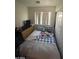 Cozy bedroom featuring a comfortable bed, natural light from a window, and a dresser at 9801 Bradford Summit St, Las Vegas, NV 89183