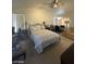 Well-lit Primary bedroom with a vaulted ceiling, a comfortable bed, and cozy seating at 9801 Bradford Summit St, Las Vegas, NV 89183