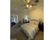 This bedroom has a ceiling fan, an ironing board, and bright natural lighting at 9801 Bradford Summit St, Las Vegas, NV 89183