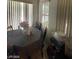 Cozy dining area with a table, chairs, and bright natural light from the large window at 9801 Bradford Summit St, Las Vegas, NV 89183