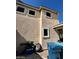 Side view of home highlighting a well-kept exterior, porch, and attached garage, adjacent to a paved driveway on a sunny day at 9801 Bradford Summit St, Las Vegas, NV 89183