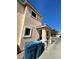 Side view of home highlighting a well-kept exterior, porch, and attached garage, adjacent to a paved driveway on a sunny day at 9801 Bradford Summit St, Las Vegas, NV 89183