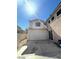 Garage door of home highlighting a well-kept exterior and attached garage, adjacent to a paved driveway on a sunny day at 9801 Bradford Summit St, Las Vegas, NV 89183