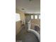 Bright hallway featuring multiple windows, access to rooms, and a carpeted floor at 9801 Bradford Summit St, Las Vegas, NV 89183