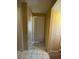 Inviting hallway featuring tile flooring and neutral wall paint provides an easy transition to the home's interior at 9801 Bradford Summit St, Las Vegas, NV 89183