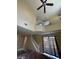 Bright and airy living room featuring a ceiling fan, stairs, and large windows at 9801 Bradford Summit St, Las Vegas, NV 89183