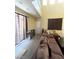 Open concept living room featuring large windows and plush carpeting and a brown couch at 9801 Bradford Summit St, Las Vegas, NV 89183