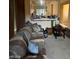 Living Room includes a partial view of the kitchen and a brown striped couch at 9801 Bradford Summit St, Las Vegas, NV 89183