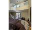 An image of the living room with a stairway and a large brown couch at 9801 Bradford Summit St, Las Vegas, NV 89183