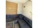 A cozy patio with a large gray L-shaped sectional sofa, fire pit, bamboo screen and a side lamp at 9801 Bradford Summit St, Las Vegas, NV 89183