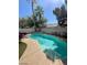 Refreshing private backyard pool surrounded by a lounge area with well-manicured trees, perfect for relaxation and outdoor enjoyment at 9801 Bradford Summit St, Las Vegas, NV 89183