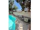 Private backyard pool area featuring a seating area and mature trees at 9801 Bradford Summit St, Las Vegas, NV 89183