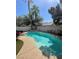 Enjoy a backyard swimming pool with desert landscaping at 9801 Bradford Summit St, Las Vegas, NV 89183