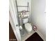 The toilet features a metal rack full of toilet paper for ample bathroom storage at 9801 Bradford Summit St, Las Vegas, NV 89183