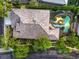 Expansive home featuring a backyard oasis with a rock-lined pool and lush landscaping at 10300 Wellside Hill Ave, Las Vegas, NV 89145